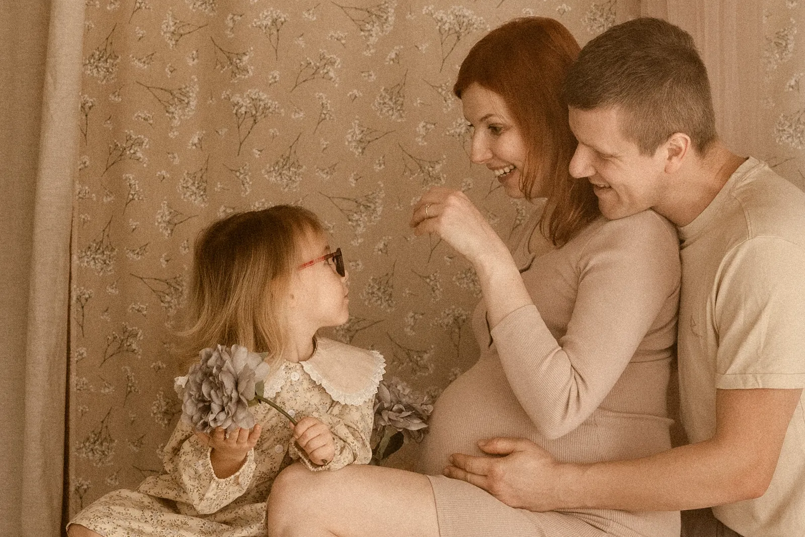 Sesja ciążowa boho z partnerem i starszym dzieckiem - naturalne ujęcie na delikatnym tle